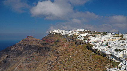 Aerial drone photo of iconic picturesque village of Imerovigli built on top of steep hill with amazing views to Caldera and Santorini island, Cyclades, Greece