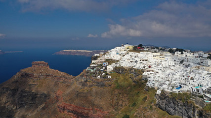 Fototapeta na wymiar Aerial drone photo of iconic picturesque village of Imerovigli built on top of steep hill with amazing views to Caldera and Santorini island, Cyclades, Greece