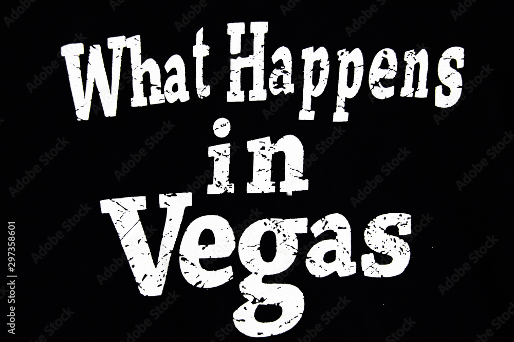 Wall mural what happens in vegas. inspirational vector quote, white ink brush lettering isolated on black backg