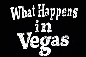 What Happens in Vegas. Inspirational vector quote, white ink brush lettering isolated on black background. Lucky saying for cards, posters and t-shirt