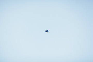 small private plane flying in the blue sky