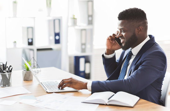 Cheerful Young Entrepreneur Having Conversation With Business Partner By Cellphone