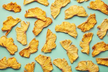 Dried pineapple on colored background. Pattern of a pineapple frips. Healthy eating