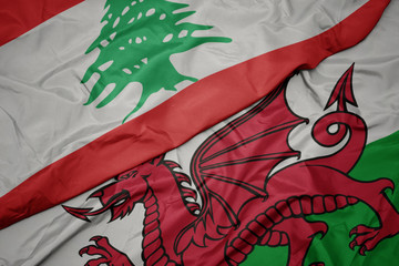 waving colorful flag of wales and national flag of lebanon.