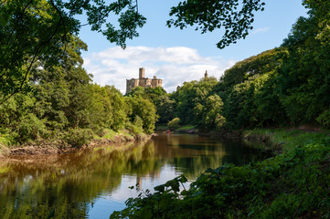 Fototapeta na wymiar Warkworth Castle and the River Coquet in Morpeth, Northumberland, UK on a sunny day