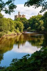 Fototapeta na wymiar Warkworth Castle reflected in the River Coquet, Morpeth, Northumberland, UK