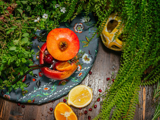 Alcoholic cocktail poured inside pomegranate. Pomegranate is used as a glass.