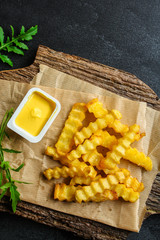 french fries and sauce (delicious snack, fast food, deep fried potatoes) menu concept. food background. copy space. Top view