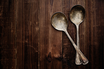 Old spoons on wood. Top down view.
