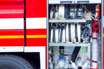 Fire engine, side view, neatly folded equipment inside the fire engine.