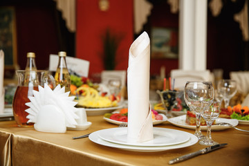catering at a top event, glasses and flowers on the table, preparation for a significant event, beautiful dishes and glasses on the table, New Year's holiday table
