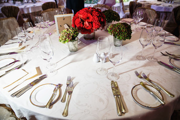 catering at a top event, glasses and flowers on the table, preparation for a significant event, beautiful dishes and glasses on the table, New Year's holiday table