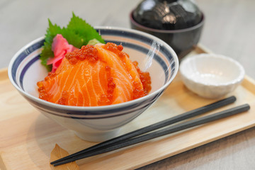 Japanese food Salmon sashimi, salmon's egg (ikura), shredded radish and slice ginger with japanese rice donburi,Salmon don.