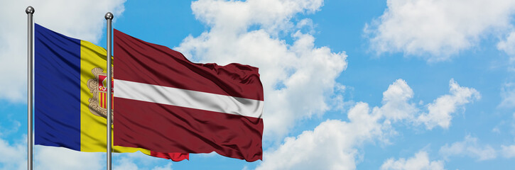 Fototapeta na wymiar Andorra and Latvia flag waving in the wind against white cloudy blue sky together. Diplomacy concept, international relations.