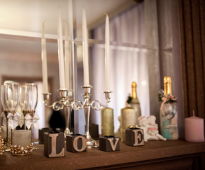 Wedding Decoration. Candleholder and wooden love letters in the mirrow reflection background.