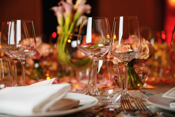 catering at a top event, glasses and flowers on the table, preparation for a significant event, beautiful dishes and glasses on the table, New Year's holiday table