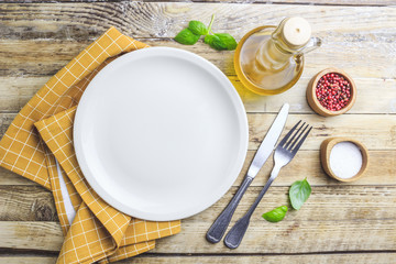 Elegant empty plate, cutlery and napkin