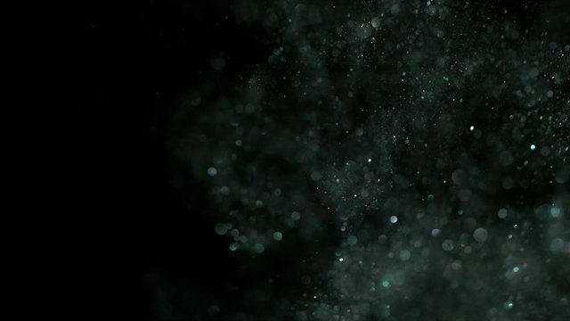 Super slow motion of glittering silver particles on black background. Shallow depth of focus. Filmed on high speed cinema camera, 1000 fps.