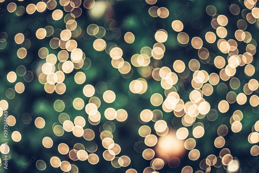 Poster Abstract blur decoration ball and light string on christmas tree with bokeh light background.winter holiday seasonal
