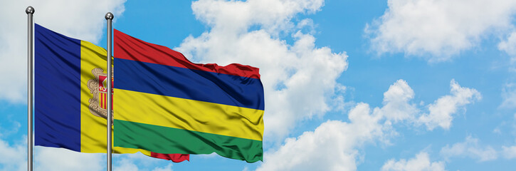 Andorra and Mauritius flag waving in the wind against white cloudy blue sky together. Diplomacy concept, international relations.
