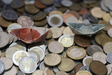coins bills billetes de curso legal de euros hechos barquitos de papel navegando sobre monedas del...