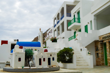 White stairs in romantic backstreet alley lane alleyway street with traditional typical Greek white buildings and colorful blue white buildings and balconies on Sifnos in Greece
