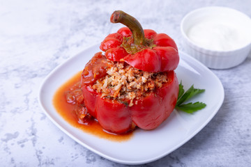Peppers stuffed with meat, rice and vegetables with tomato sauce and sour cream. A traditional...