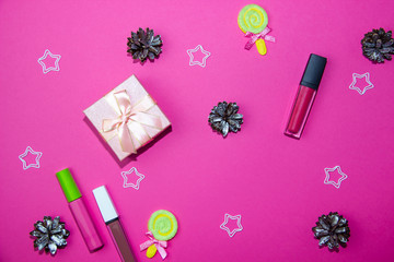 New Year decorations on a bright pink background. Gift box, Christmas cones and stars on a Christmas background.