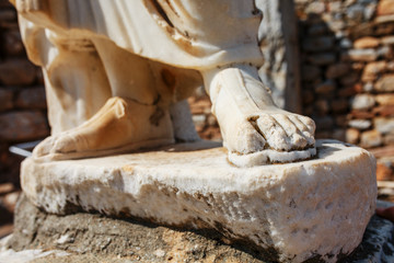 Elements of marble legs of an ancient statue of the ruined city of Ephesus in Turkey.