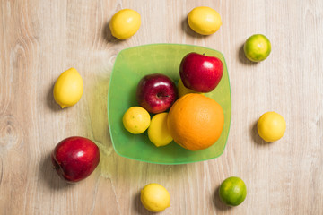 Naklejka na ściany i meble Fruit studio image. Bowl of fruit. Set of citrus fruits and red apples.