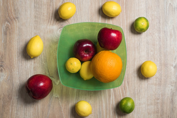 Fruit studio image. Bowl of fruit. Set of citrus fruits and red apples.