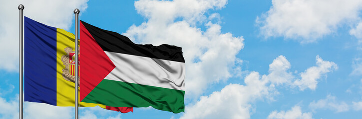 Andorra and Palestine flag waving in the wind against white cloudy blue sky together. Diplomacy concept, international relations.