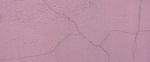 Old light pink plaster wall texture background. Abstract painted cracked wall surface