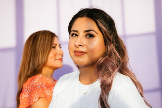 Portrait of Latina mother and daughter in studio environment