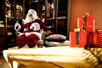 Fototapeta na wymiar Table background of free space for your decoration and red old Santa Claus in home interior. 