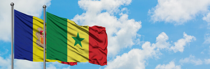 Andorra and Senegal flag waving in the wind against white cloudy blue sky together. Diplomacy concept, international relations.