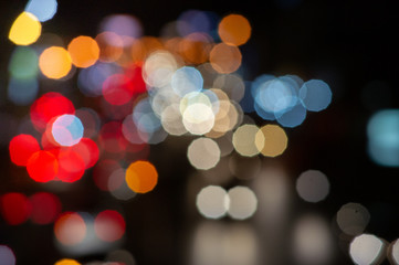 Bokeh night light on the avenue Light night at city blue bokeh sky festival abstract background blur lens flare reflection beautiful circle street with dark