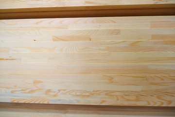 Side view of stack of two-layer wooden glued laminated timber beams from pine finger joint spliced boards