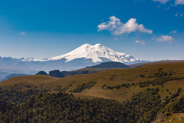 View of the peaks of Mount Elbrus with clouds in the sky.