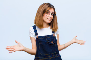 young pretty woman feeling puzzled and confused, unsure about the correct answer or decision,...