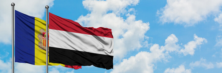 Andorra and Yemen flag waving in the wind against white cloudy blue sky together. Diplomacy concept, international relations.