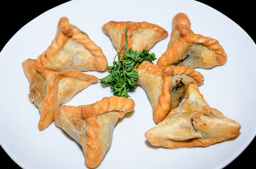 oriental samsa in a plate on a black background