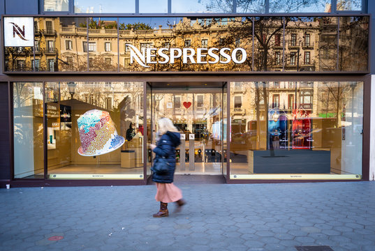 Barcelona, Spain. February 2019: People walking in front of Nespresso store.