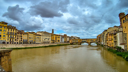 Naklejka premium Ponte Vecchio bridge across Arno river in Florence, Italy. View from Ponte Santa Trinita