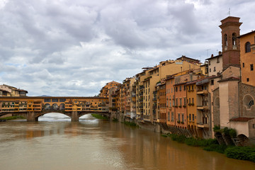 Fototapeta premium Ponte Vecchio bridge across Arno river in Florence, Italy. View from Ponte Santa Trinita