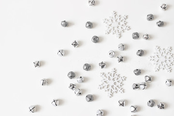 Christmas styled stock composition. Glittering jingle bells, silver dust and snowflakes decoration...