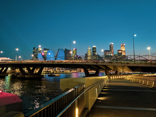 Helix Bridge and Raffles Place CBD in Singapore at night