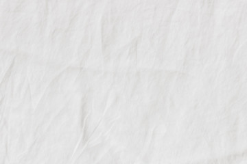 White crinkle linen texture. Closeup of fabric, tablecloth or bed linen. Light empty copy space.