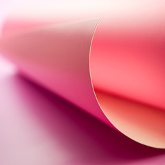 detailed roll of pink paper on a light background.