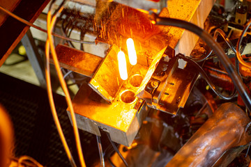Glassworks. Glass industry. Burning blanks of glass bottles in an industrial stove